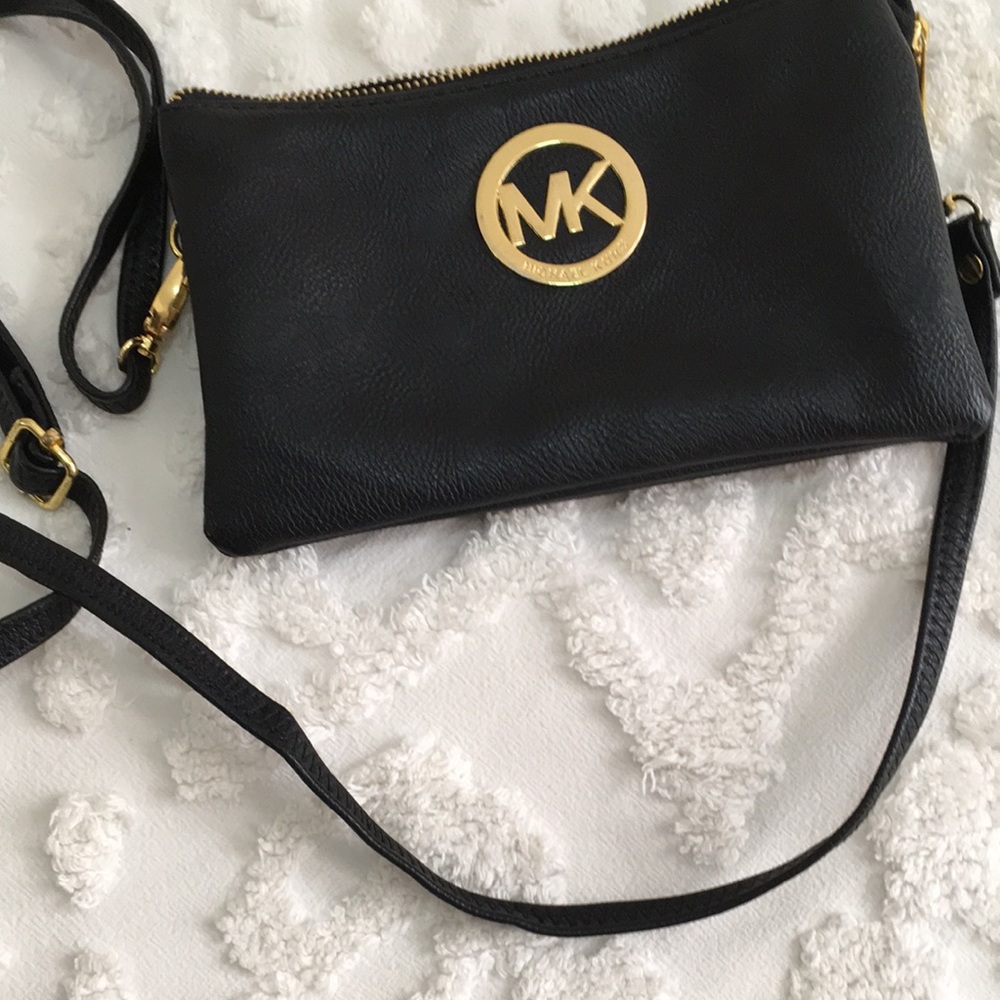 Small Michael Kors crossbody bag black leather with brass hardware.